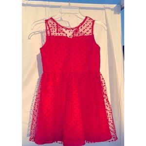 Adorable above the knee red dot sleeveless style dress with tulle. Size 10.
